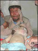 A bereaved Afghan father weeps over the body of his son, killed by USA ?liberators?. Where will this man go for justice?