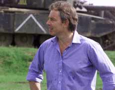 Tony Blair puts his hands on his hips to prove that he can be as macho as the people he sends to murder Iraqis.