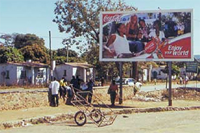 Enjoy your world! Africans wait by the roadside, in hope of exploitation in the form of a day's work.