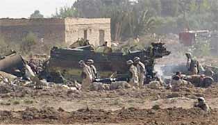 Soldiers carry a stretcher at the scene of the attack against the Chinook helicopter near Fallujah.