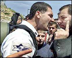 A Palestinian tries to reason with an arrogant and aggressive Israeli soldier, who refuses to let him attend mosque for prayers.