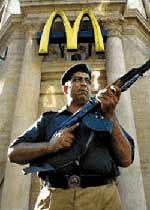 Spreading democracy, ?war on terror? style. A policeman guards a McDonalds restaurant inside the Pakistani dictatorship.