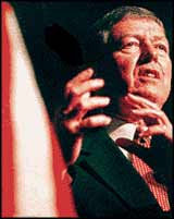 Attourney General, Christian capitalist, John Ashcroft puts his words of hate into a gesture.