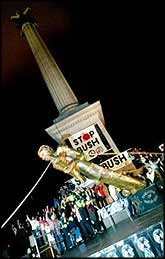 A statue of George W Bush is toppled in London's Trafalgar Square, in a renactment of the destruction of Saddam Hussein's statue in Baghdad, as part of demonstrations against Bush's visit to London.
