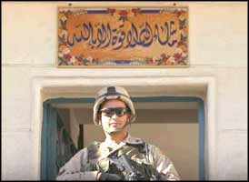 The sign above this smug G.I. reads in Arabic: 